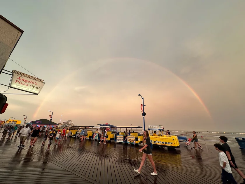 A full rainbow above the Wildwood boardwalk and yellow sightseeing tram