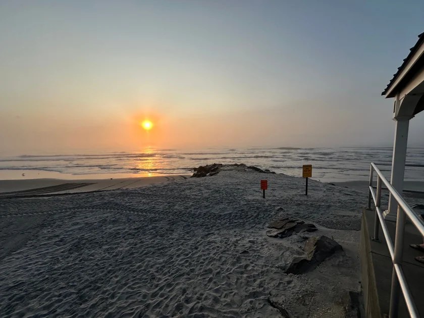 Golden sunlight across the North Wildwood shoreline, waves and sandy beach