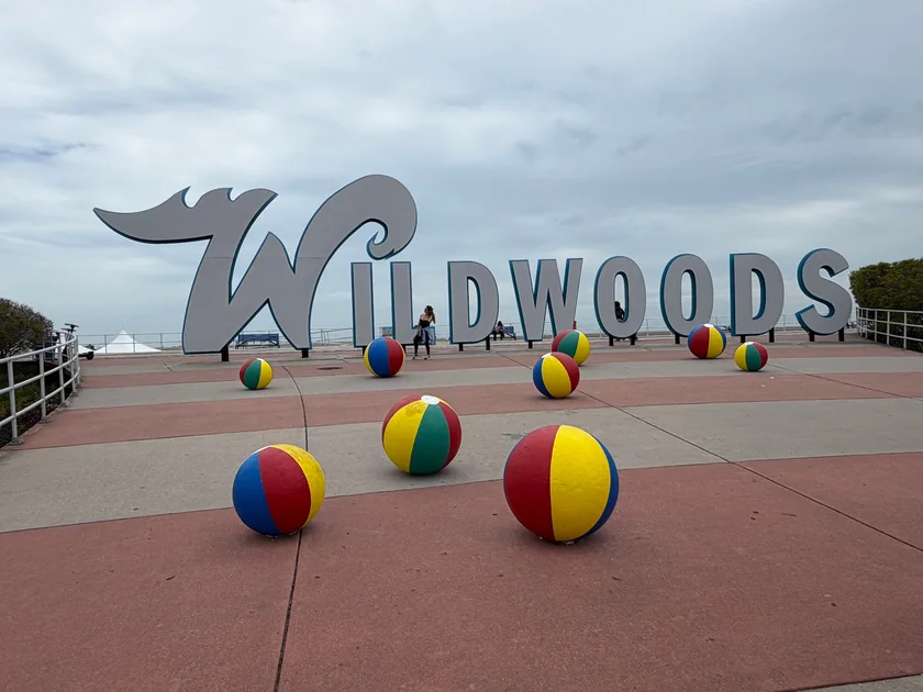 The large Wildwoods sign and colorful beach-ball sculptures on the plaza